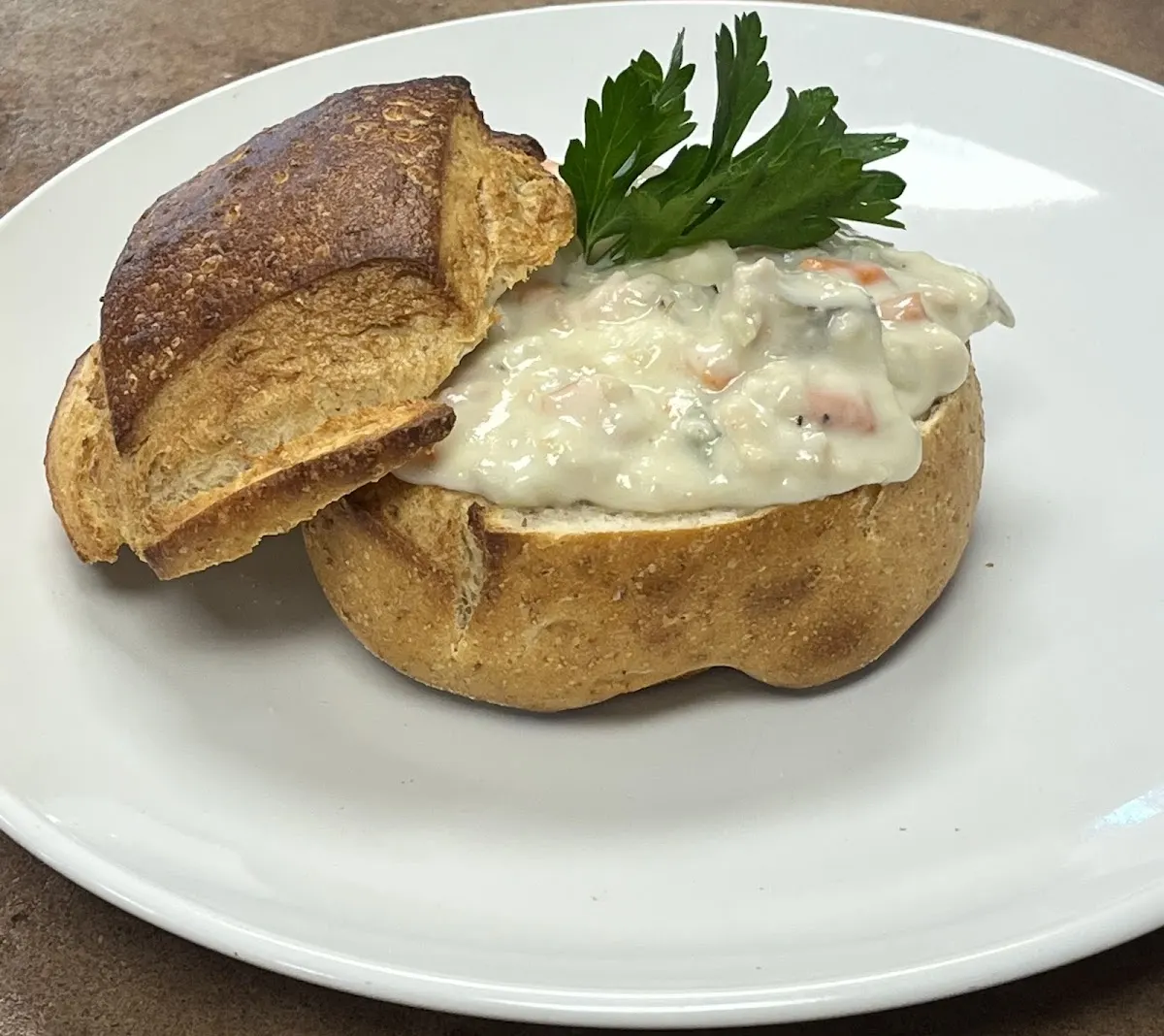 Creamy chowder served in an Italian bread bowl